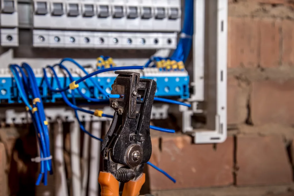 the Assembly of the electrical panel, electrician job, a robot with wires and circuit breakers | Vfix Maintenance industrial electrical maintenance dubai